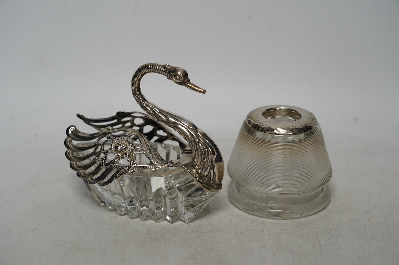 A white metal mounted glass match strike and a silver mounted swan bon bon dish, 10cm. Condition - poor to fair